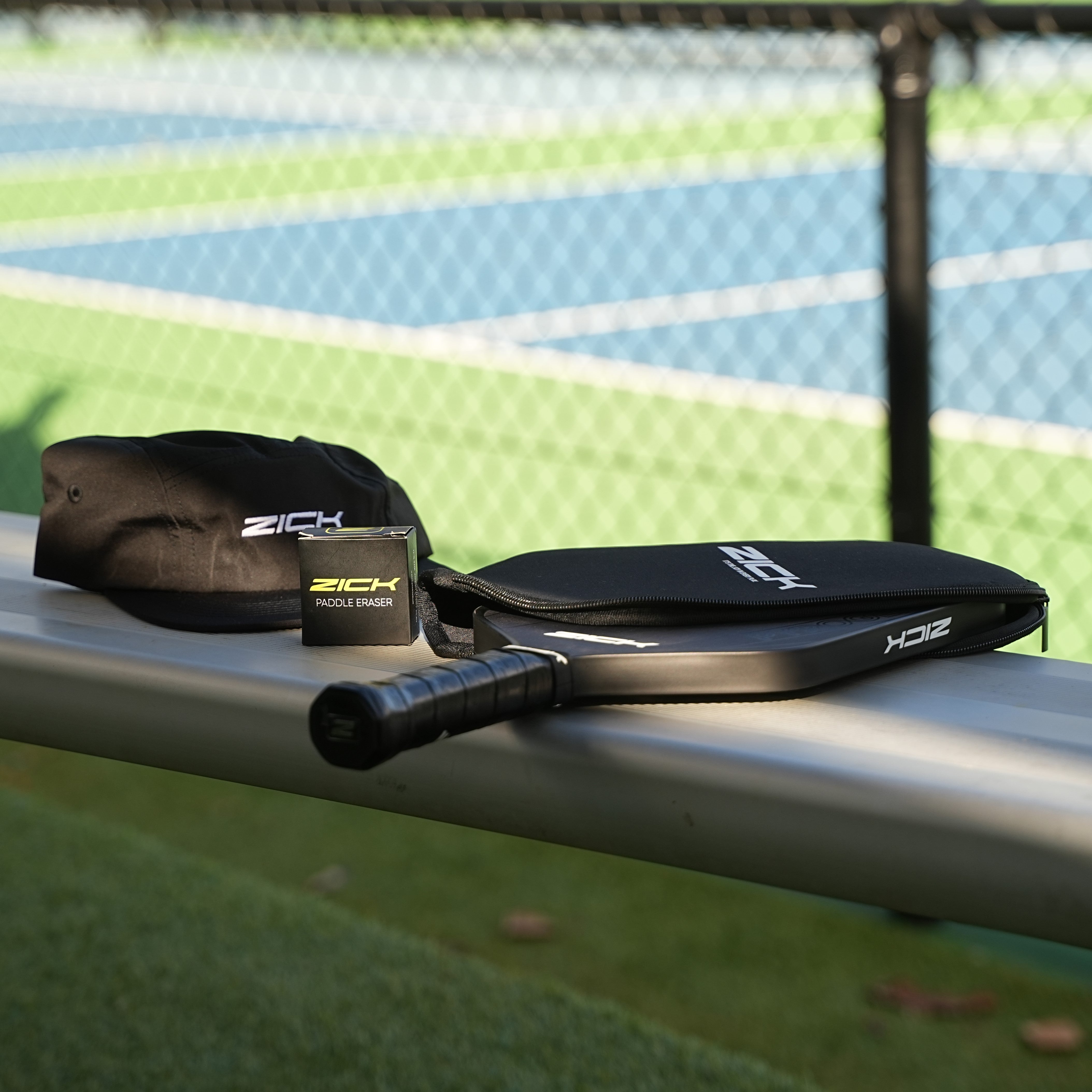 Zick Pyrogen Paddle, Crew Cap and Paddle Eraser on a bench